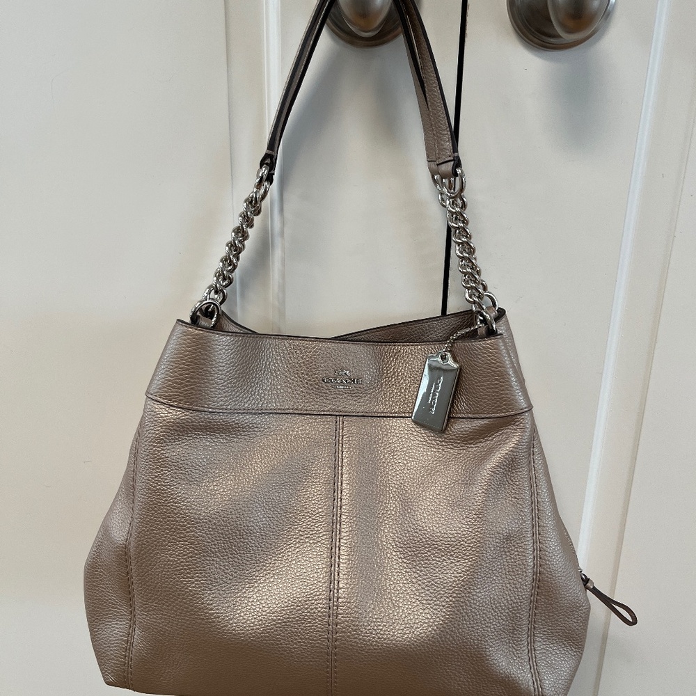 Gorgeous, new without tags pebbled leather Coach bag. Muted gold, chain detail